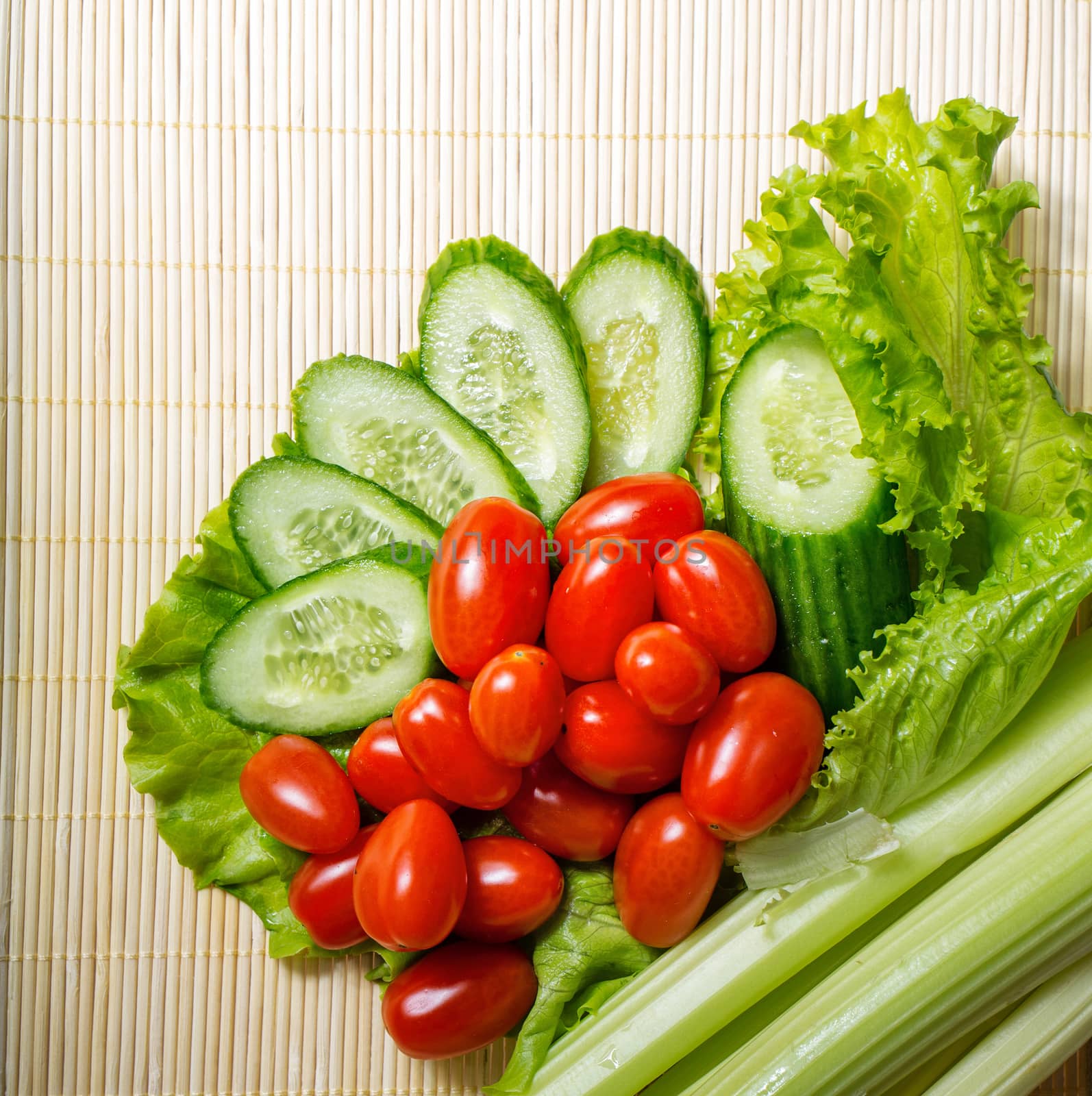 Still life close-up of lettuce, tomatoes, cucumber and celery