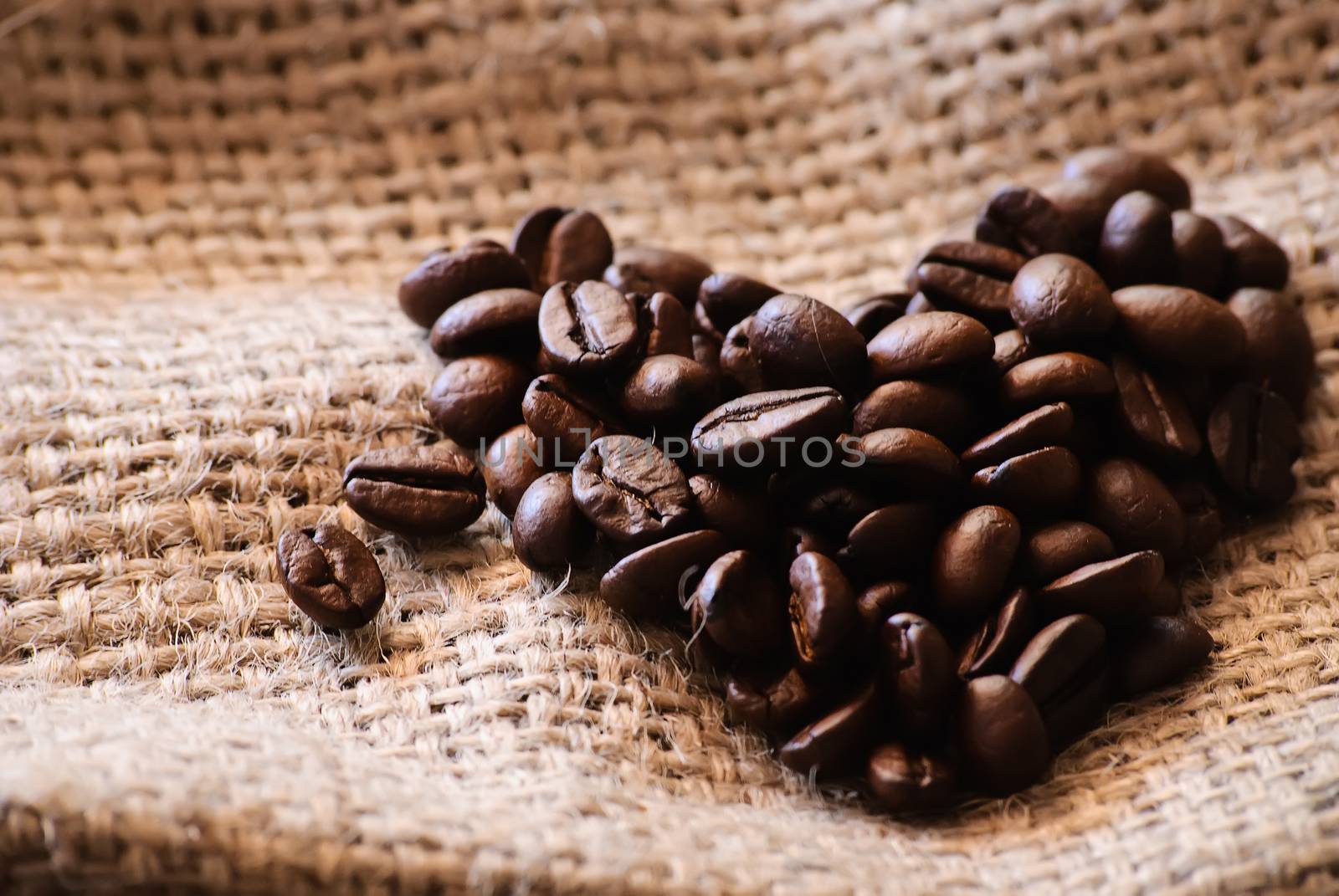 Close-up of roasted coffee beans. Heart-shaped.