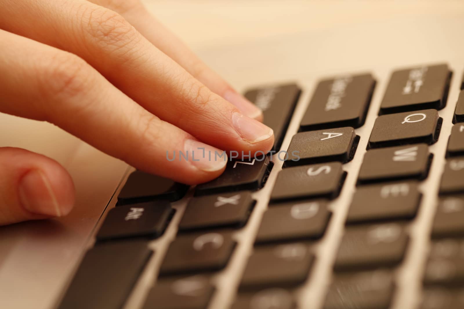 Young woman working on a gray laptop