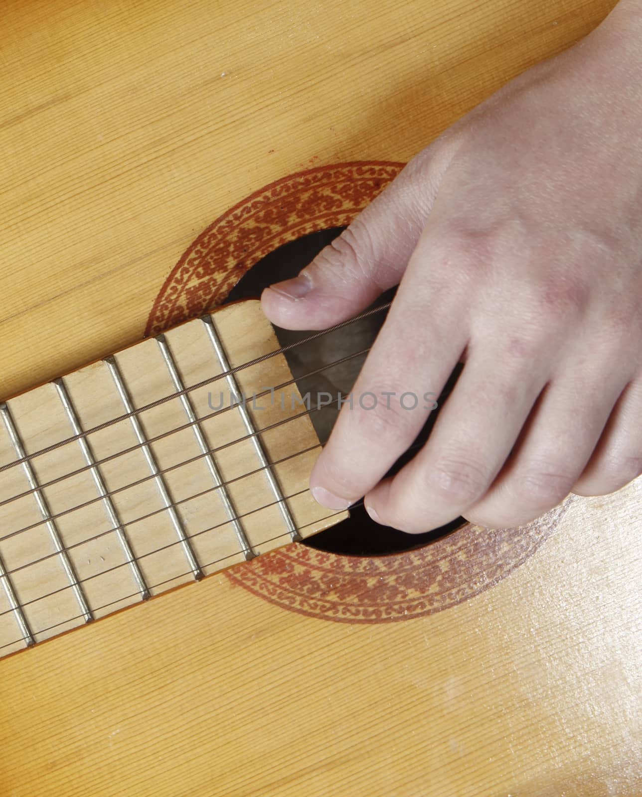 Close up photo of a Young woman playing the guitar
