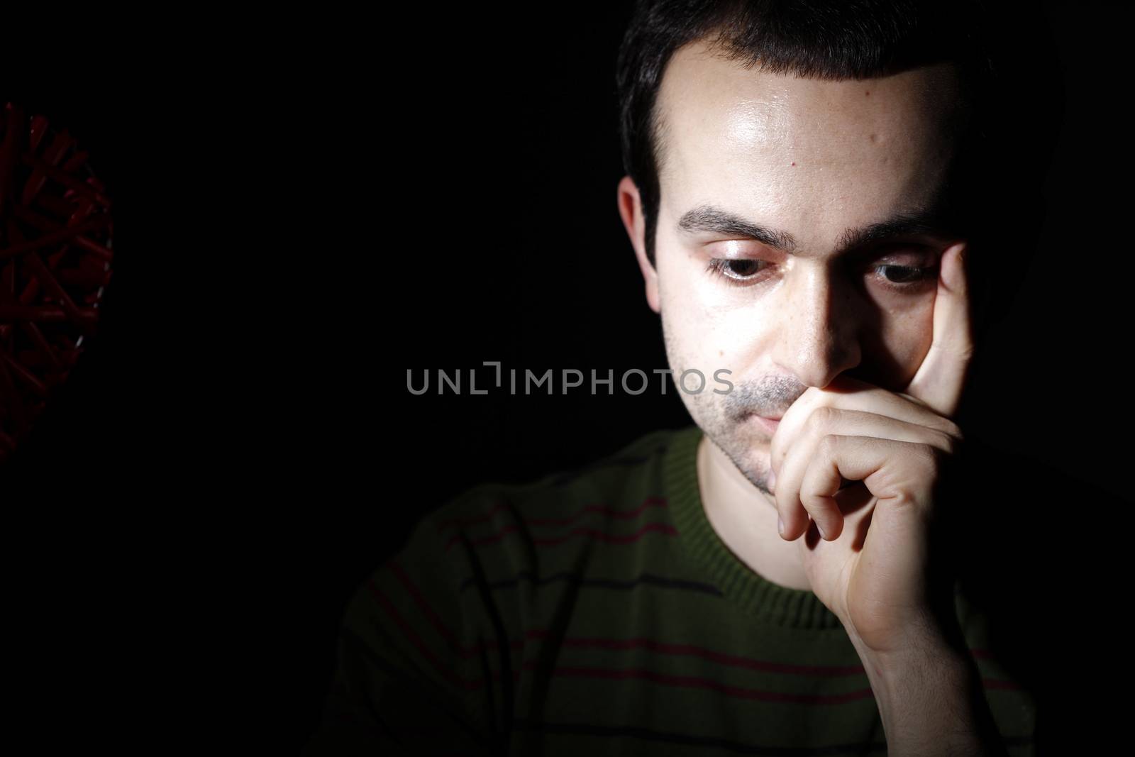 Portrait of a young man, isolated on black background