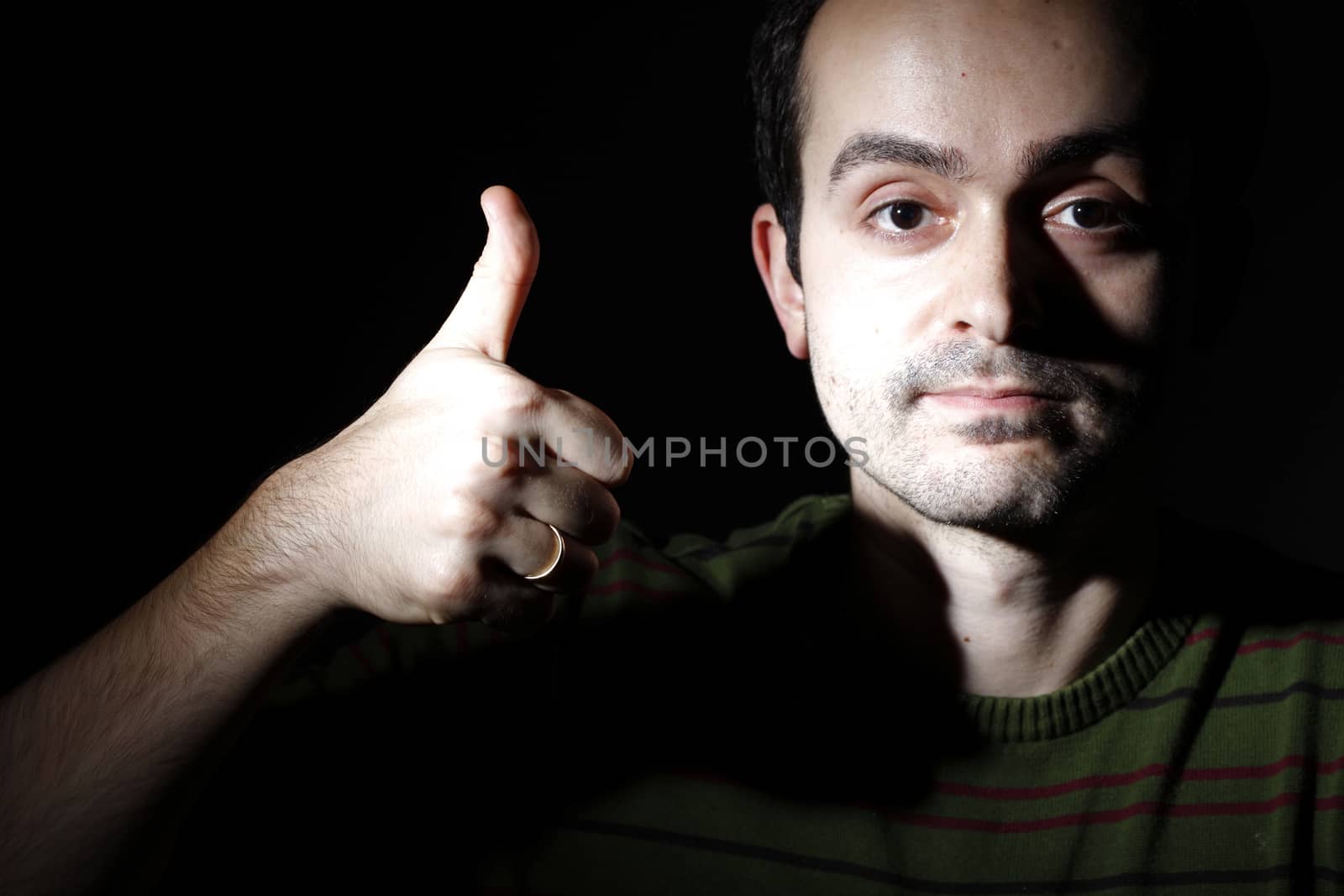 Portrait of a young man, isolated on black background