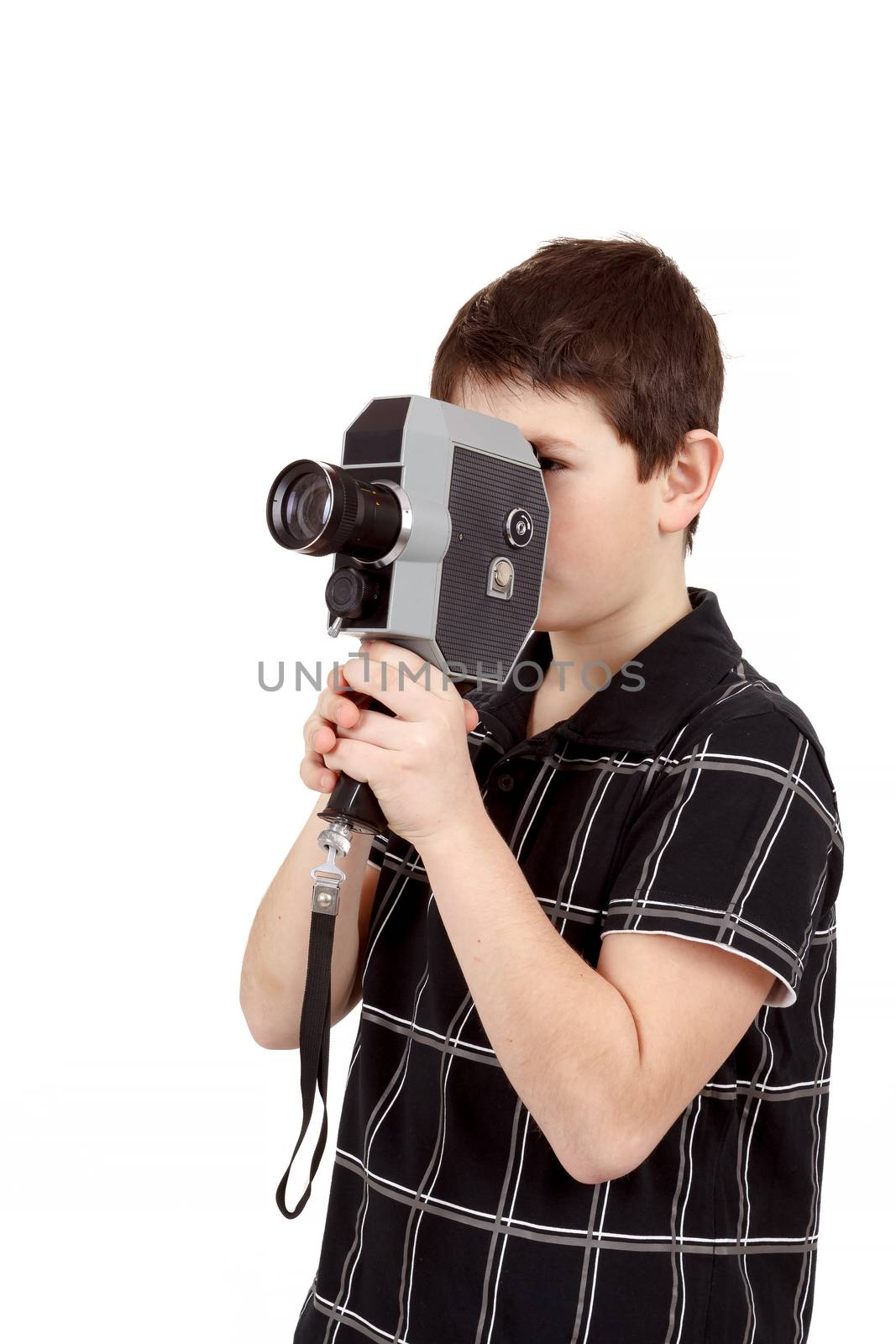 young boy with old vintage analog 8mm camera looking to viewfinder