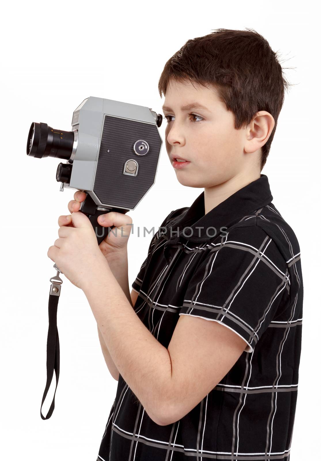 young boy with old vintage analog 8mm camera looking to viewfinder