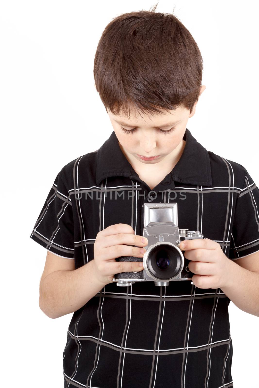 young boy with old vintage analog SLR camera looking to viewfinder