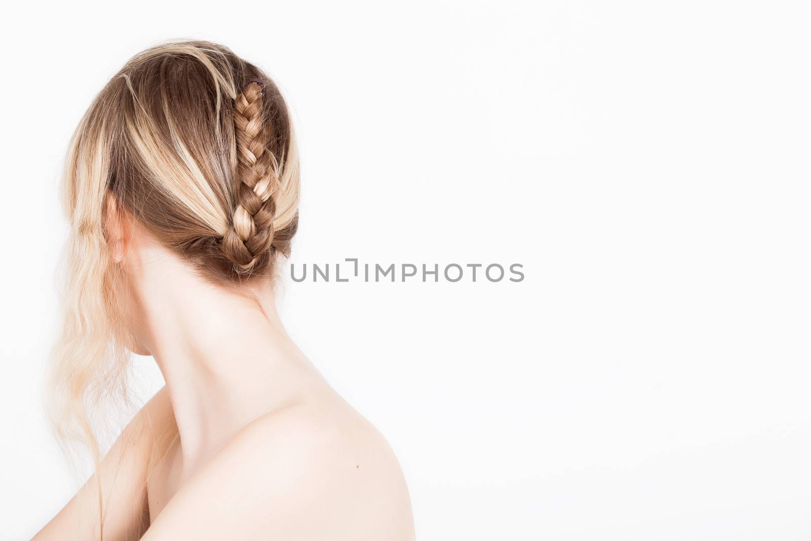 Portrait from young blond woman on a white background with much skin visible