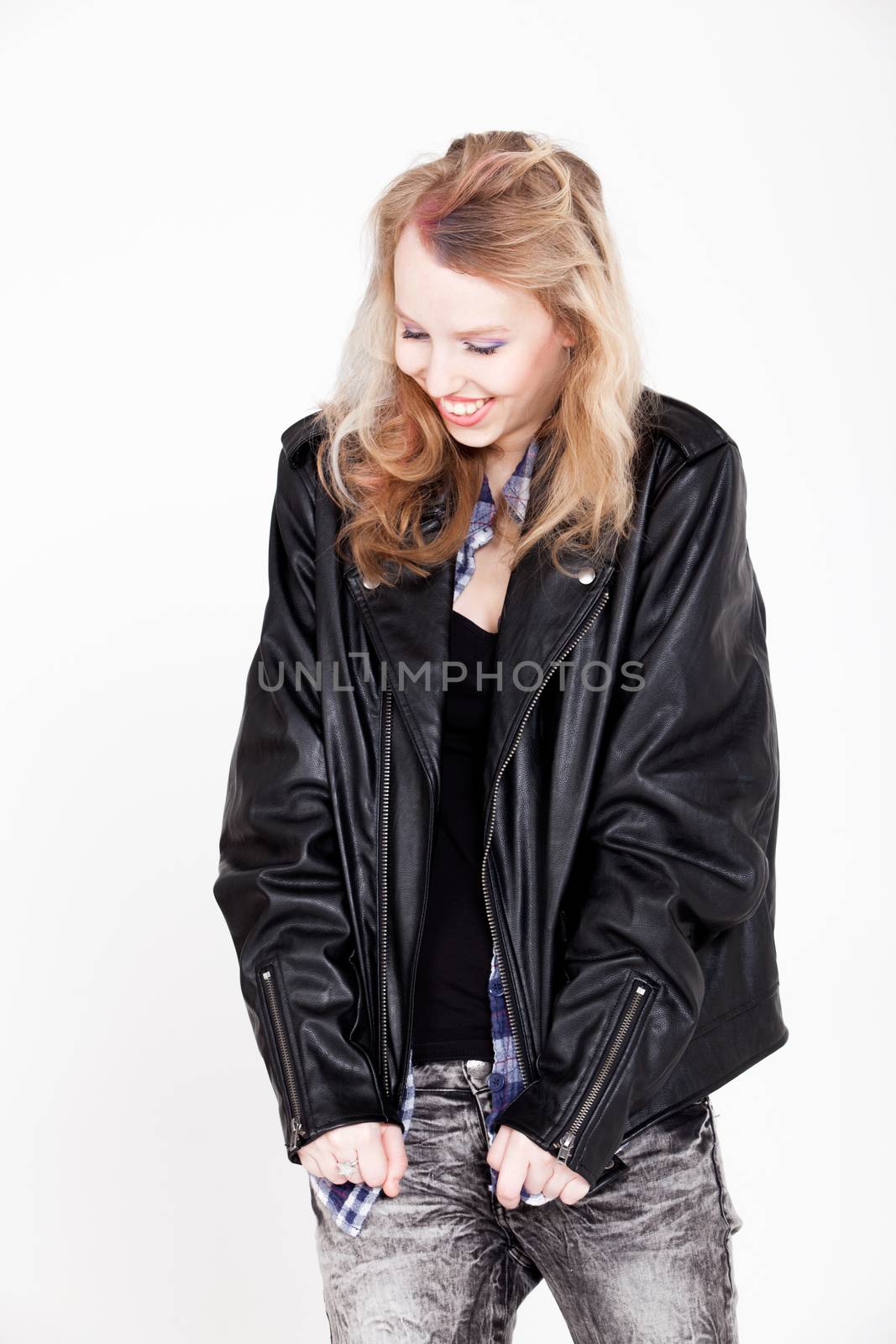 Young tough blond teenage girl with leather jacket on a white background