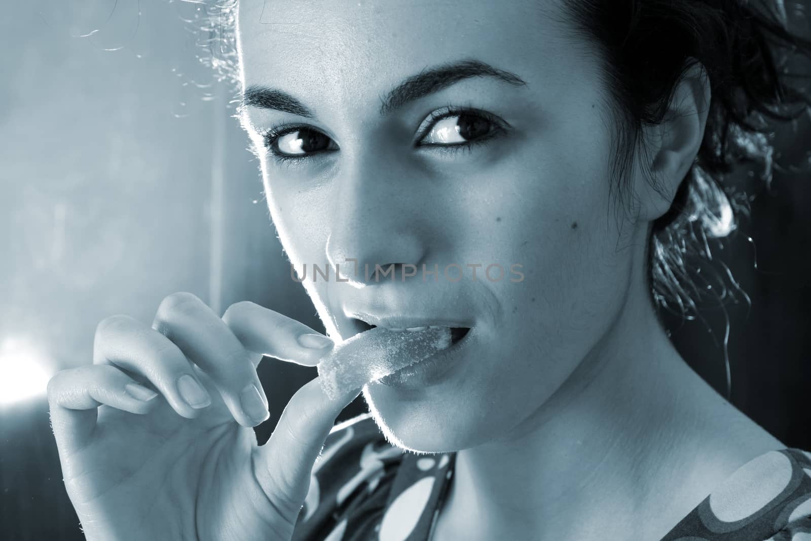 Woman eating a lemon slice.