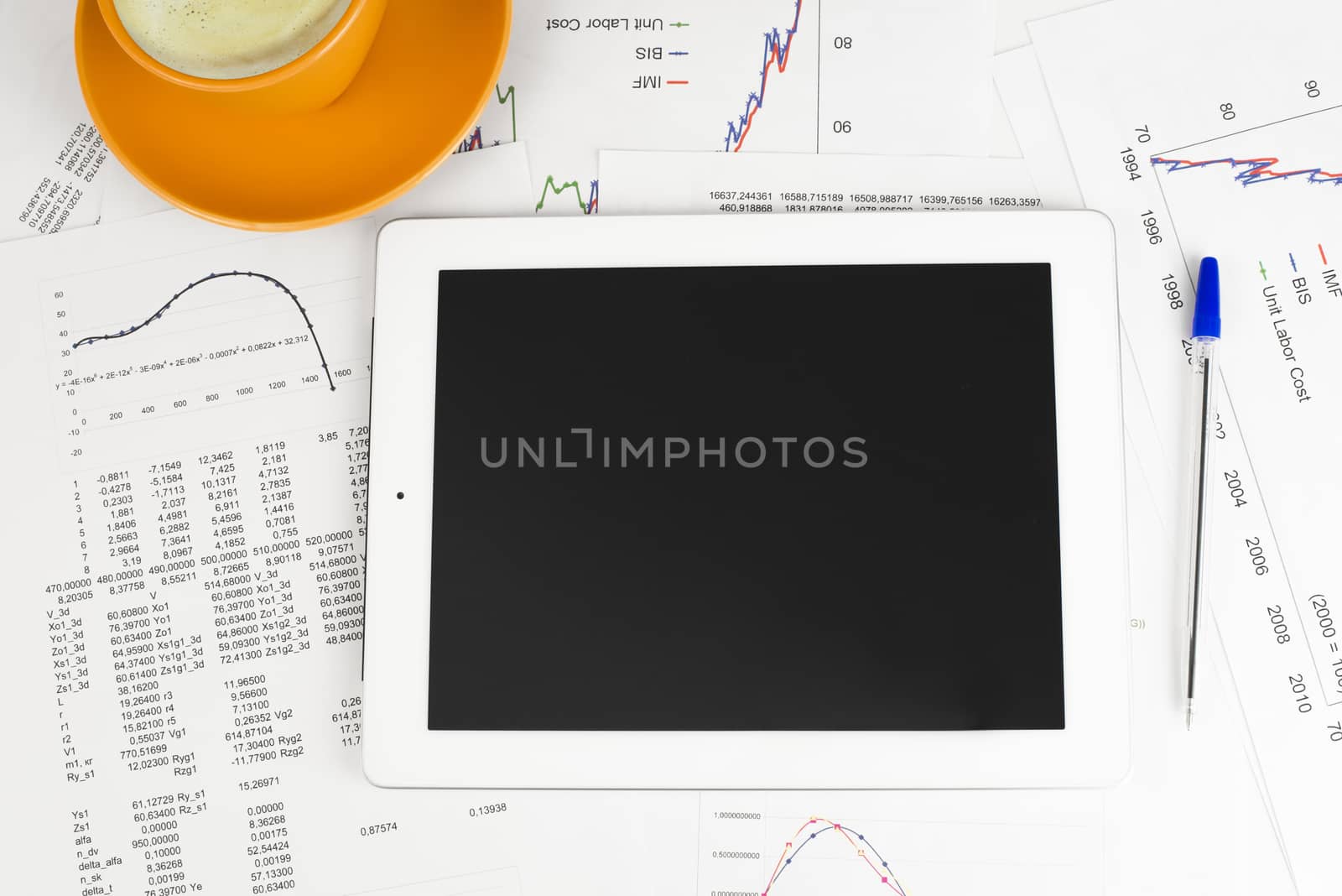 Tablet pc, cup of coffee and paper with graphs by cherezoff