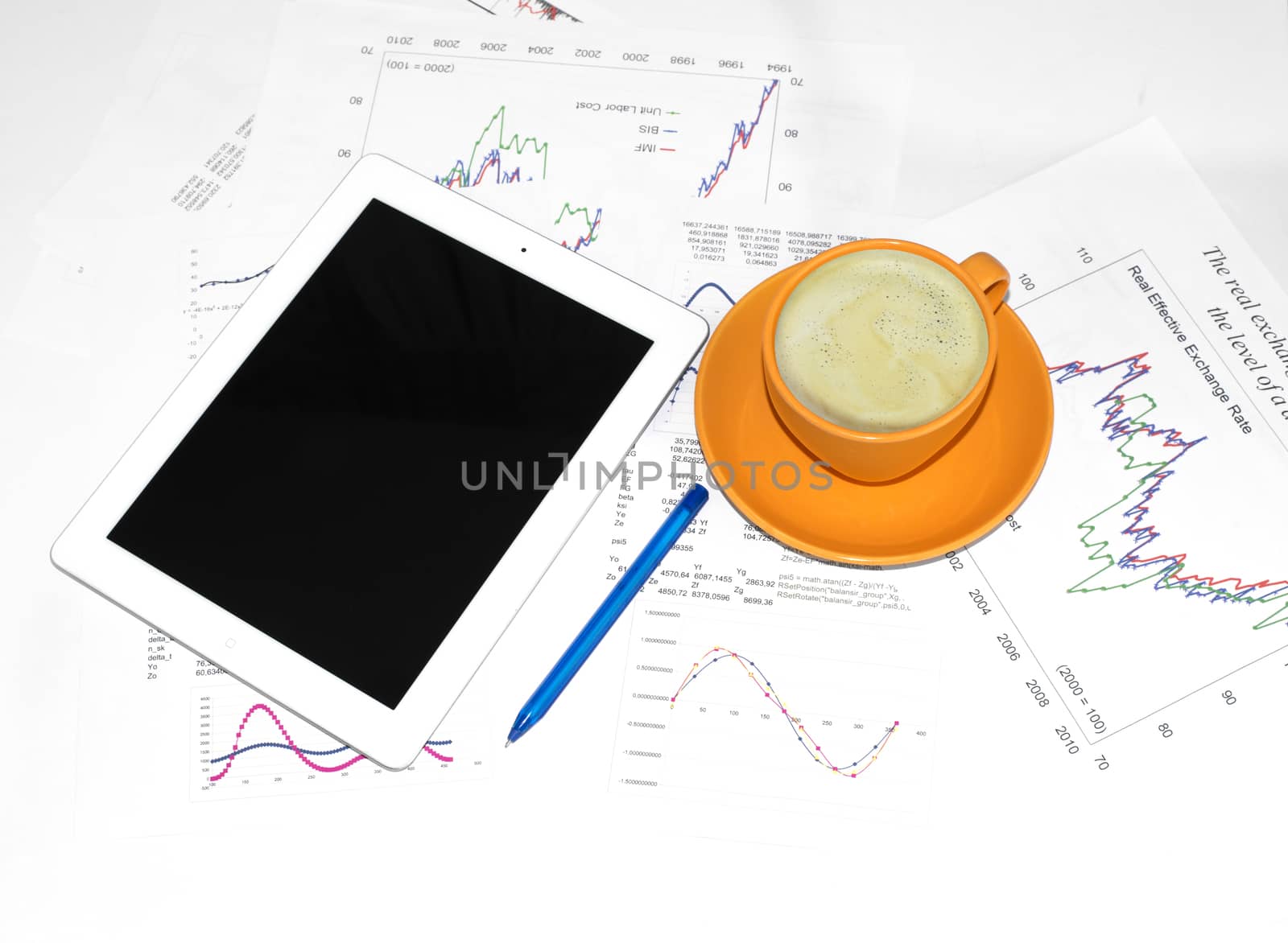 Tablet pc, cup of coffee and paper with graphs by cherezoff