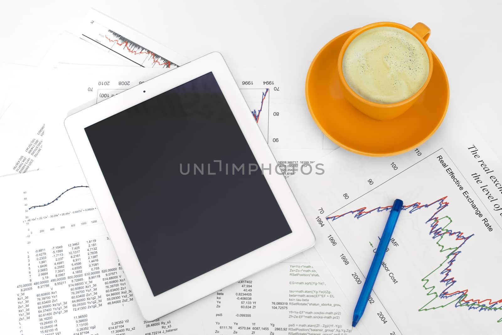 Tablet pc, cup of coffee and paper with graphs by cherezoff
