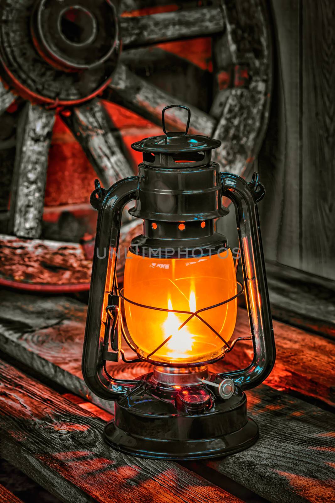 kerosene lamp  against the background wagon wheel by oleg_zhukov