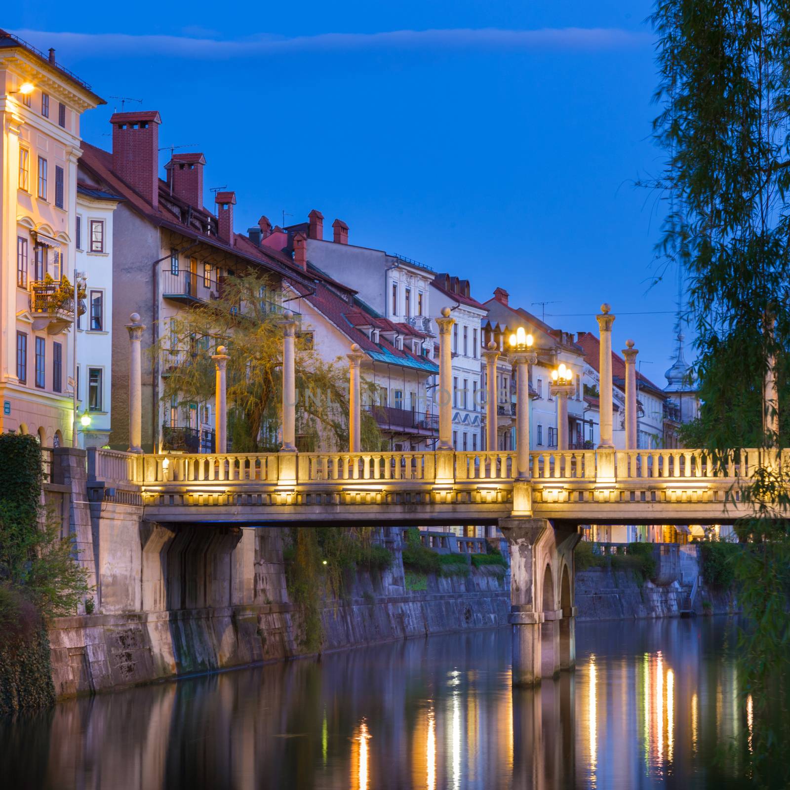 Romantic medieval Ljubljana's city center, the capital of Slovenia, Europe. Gallus bank of river Ljubljanica with Cobblers' Bridge or the Shoemakers' Bridge ( ��evljarski or ��u��tarski most ) shot at dusk.