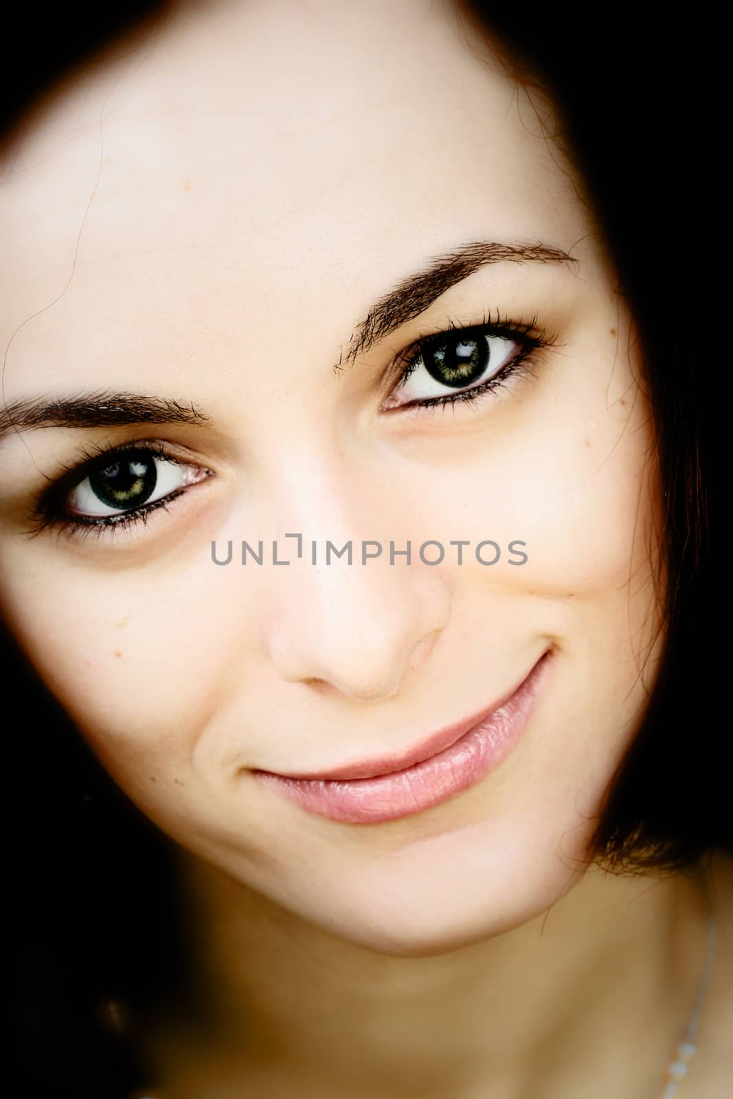 Beautiful happy woman with green eyes.