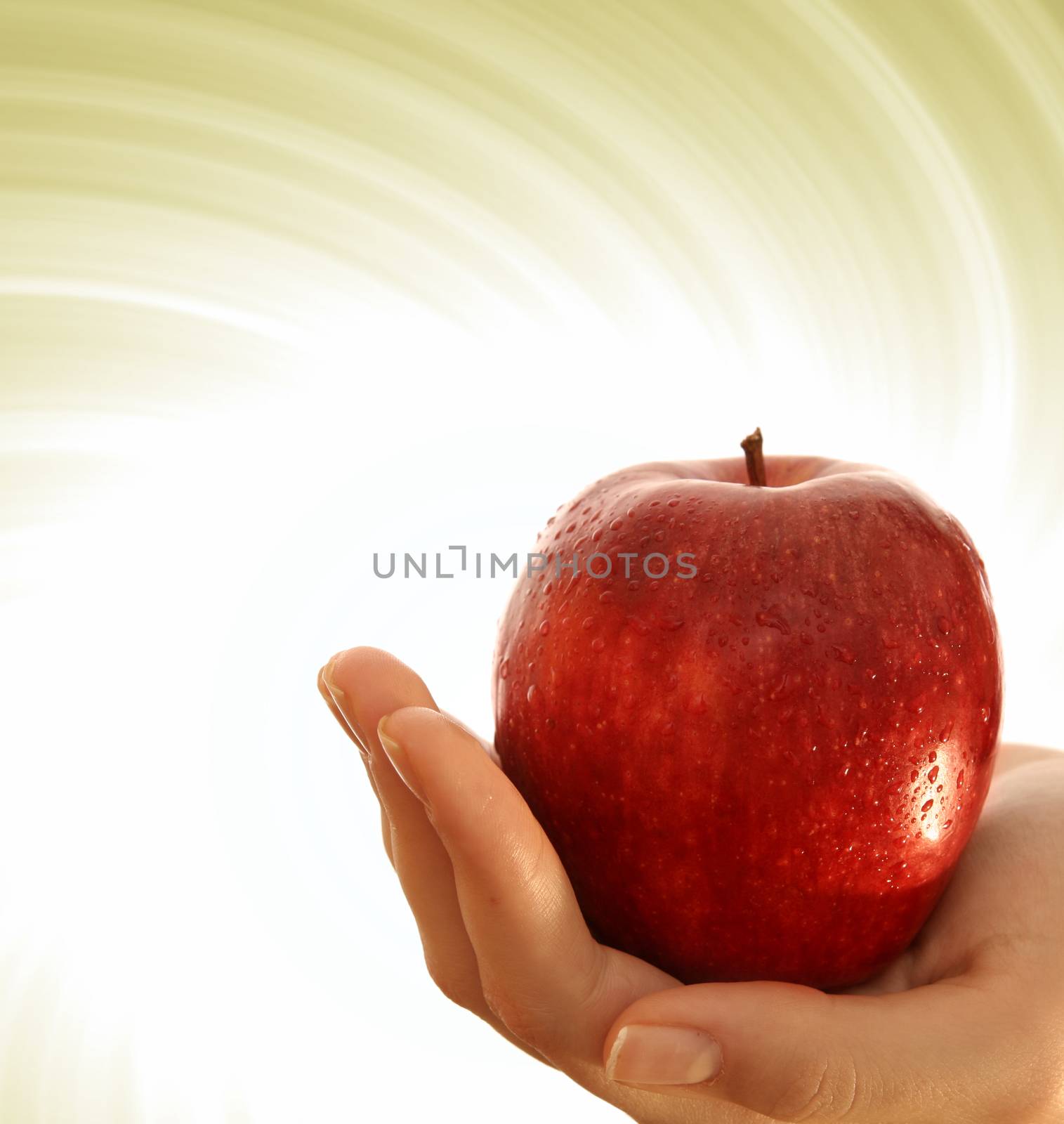 Red apple in a girl hand.