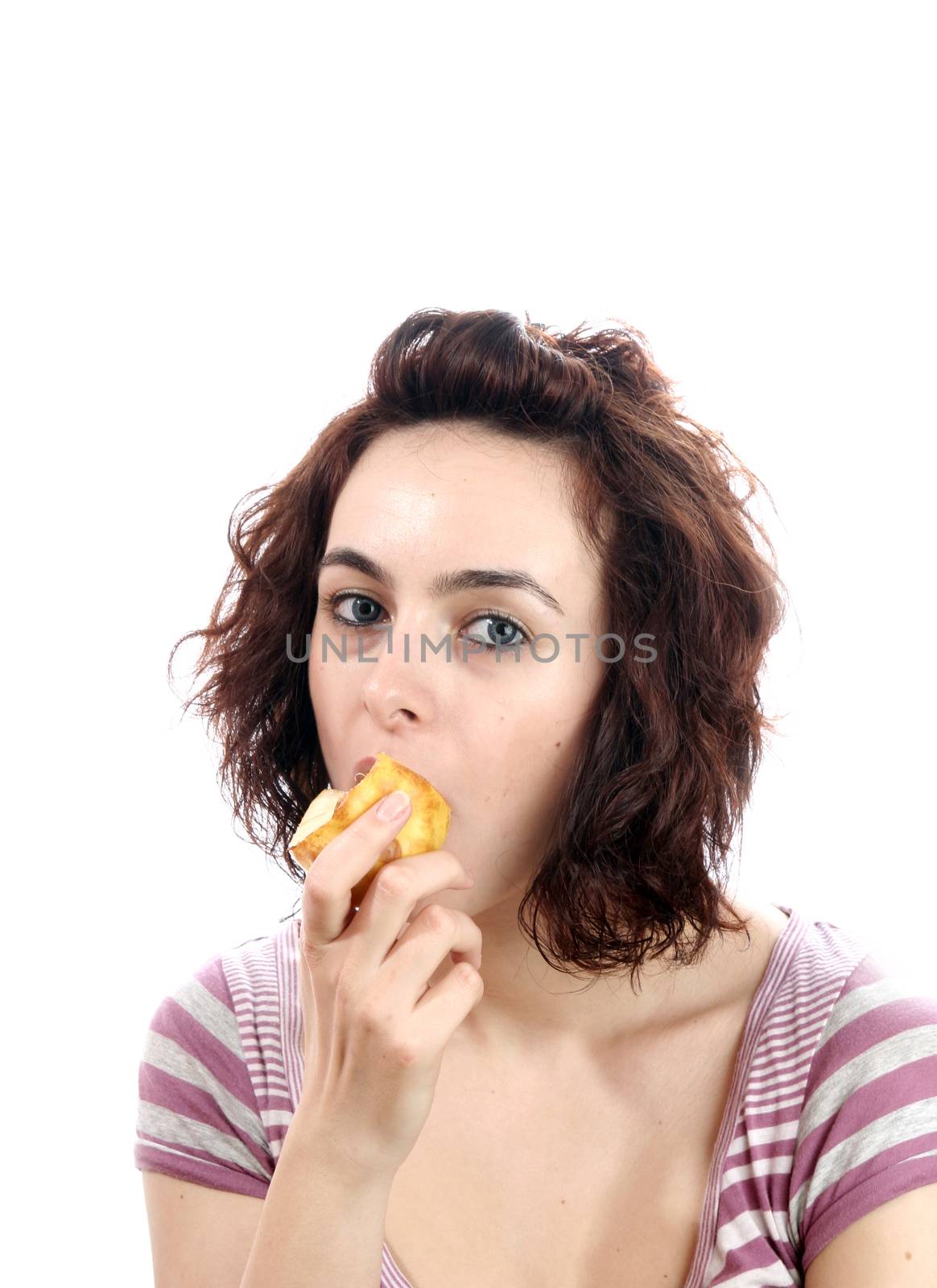 Hungry woman eating a pear