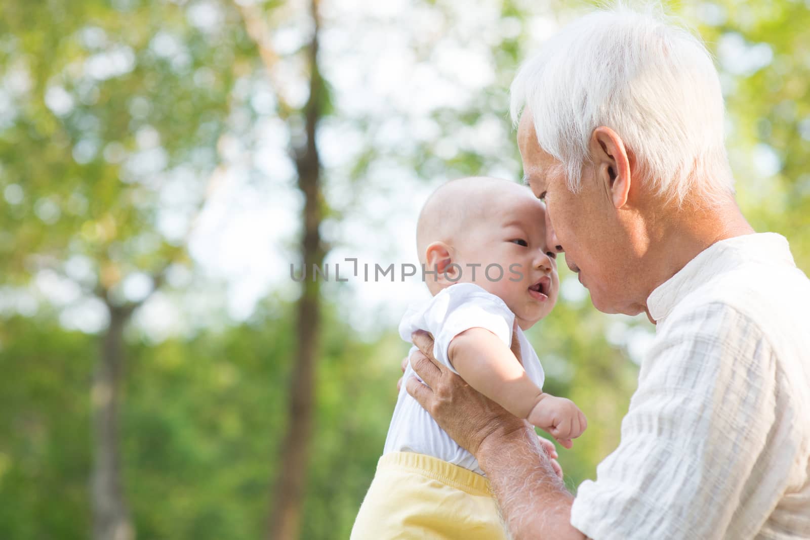 Asian grandfather kissing grandson by szefei