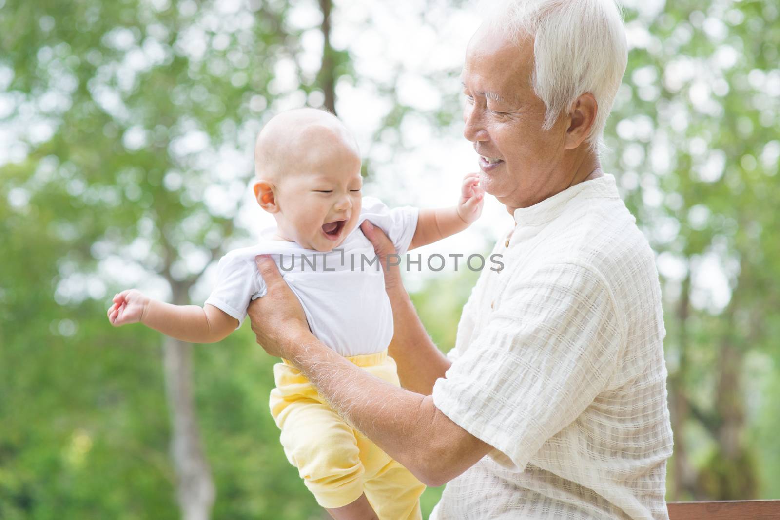 Asian grandfather playing with grandson by szefei