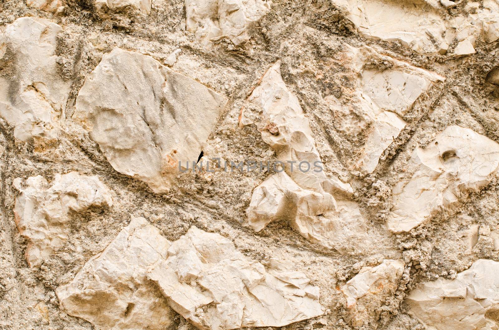 Full frame take of an old, irregular masonry wall