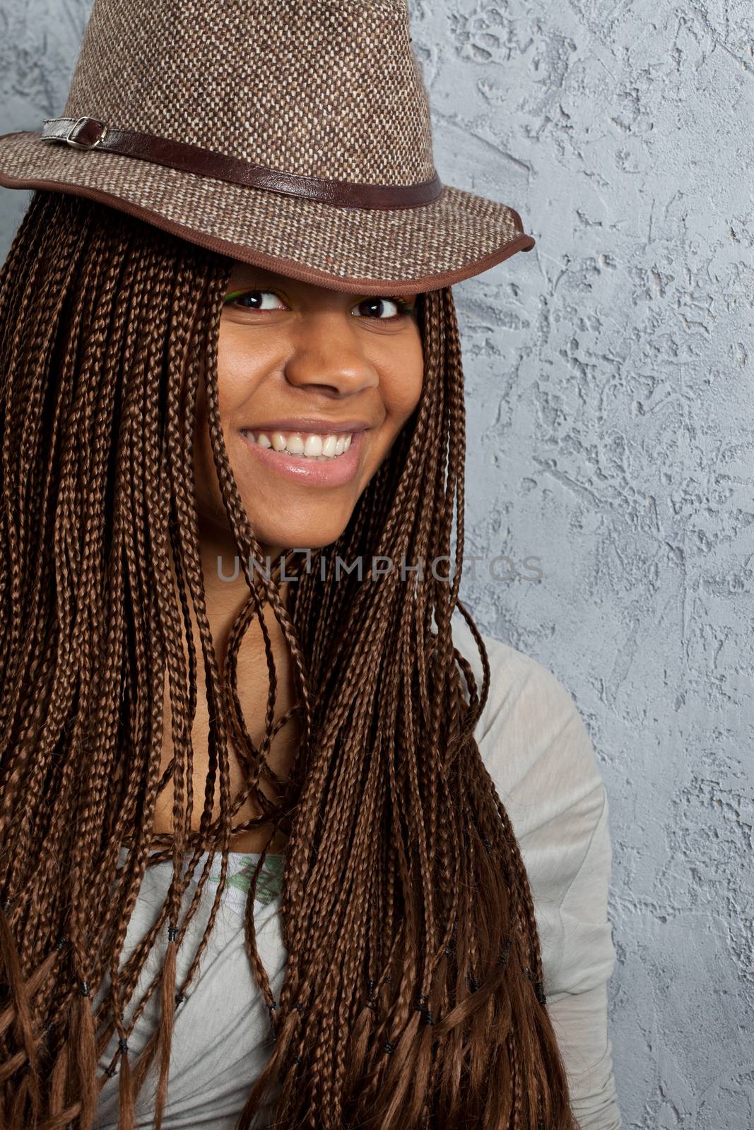 young black woman with African braids in a hat