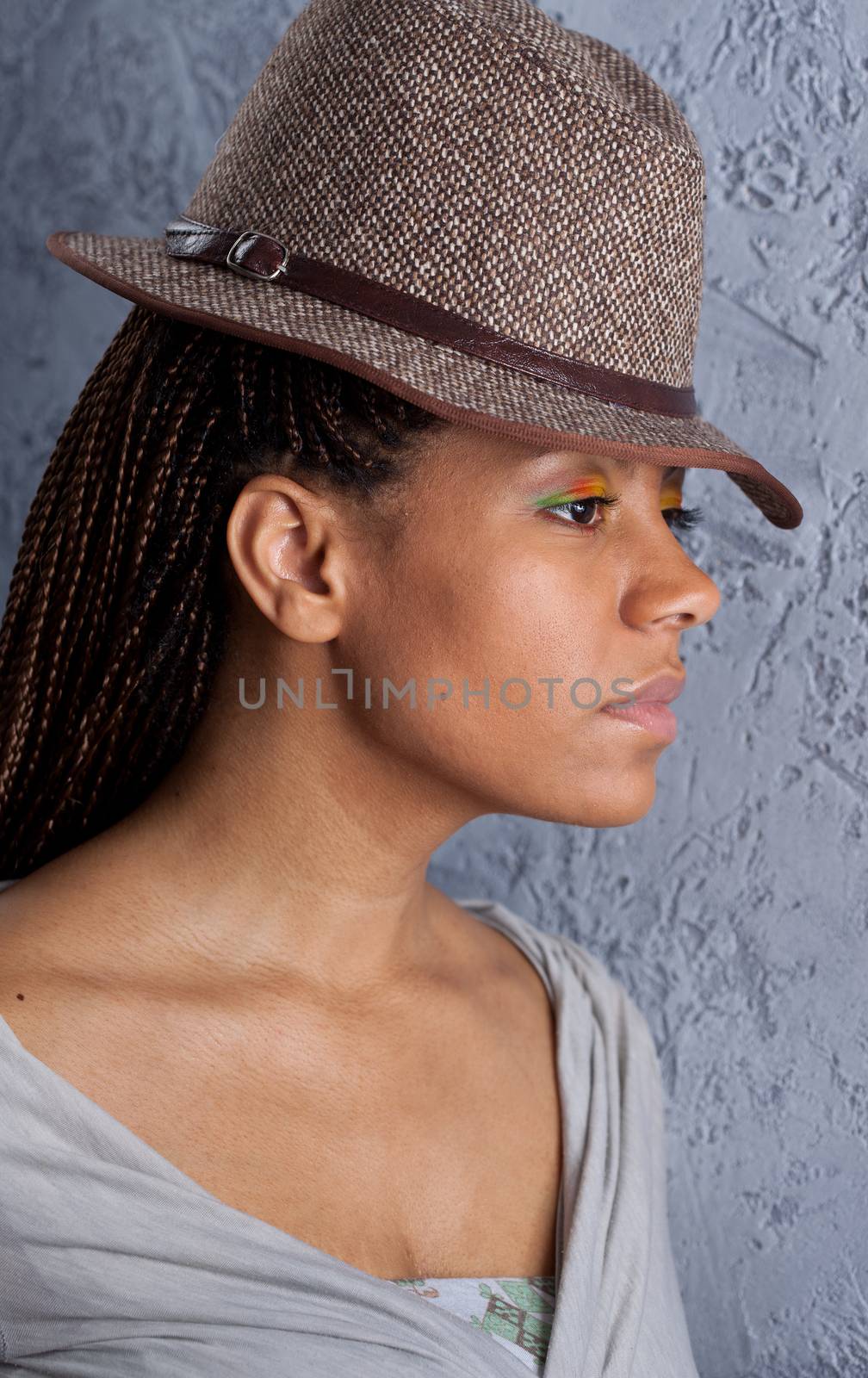 profile portrait of yong woman in a hat