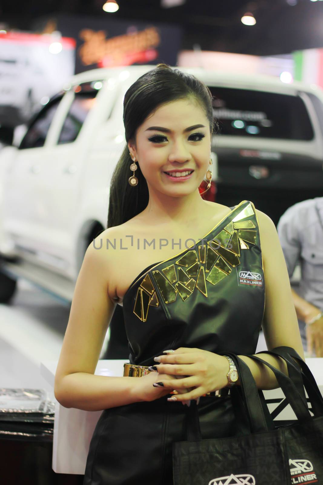 BANGKOK, THAILAND - MARCH 30, 2014: Unidentified female presenter pose in the 35th Bangkok International Motor Show on March 30, 2014 in Nonthaburi, Thailand.