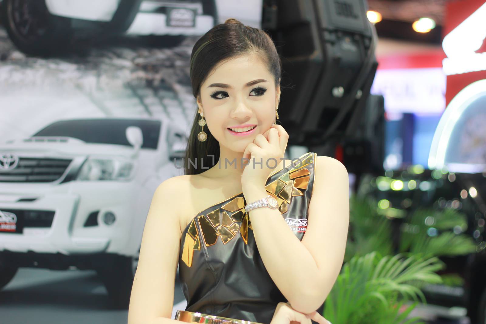 BANGKOK, THAILAND - MARCH 30, 2014: Unidentified female presenter pose in the 35th Bangkok International Motor Show on March 30, 2014 in Nonthaburi, Thailand.