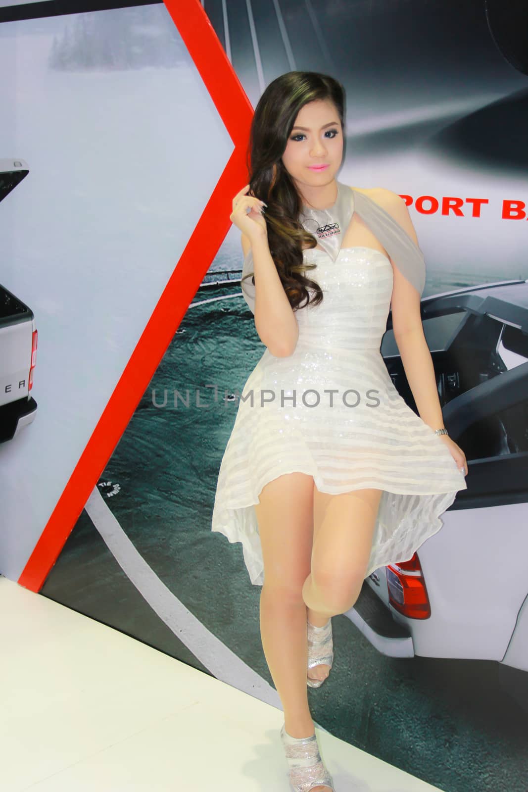 BANGKOK, THAILAND - MARCH 30, 2014: Unidentified female presenter pose in the 35th Bangkok International Motor Show on March 30, 2014 in Bangkok, Thailand.