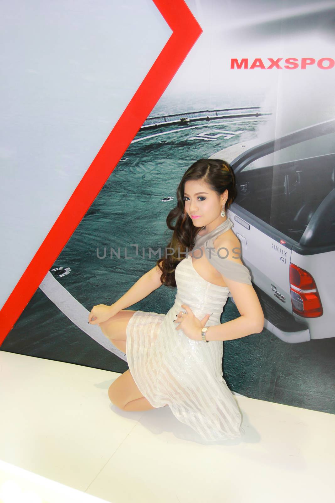 BANGKOK, THAILAND - MARCH 30, 2014: Unidentified female presenter pose in the 35th Bangkok International Motor Show on March 30, 2014 in Bangkok, Thailand.