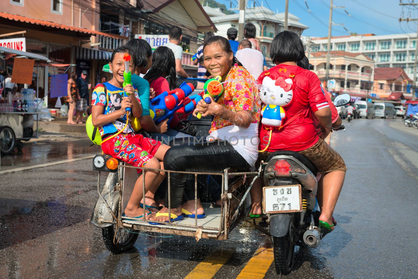 Phuket, Thailand - April 13, 2014: Tourist and residents celebrate Songkran Festival, the Thai New Year by splashing water to each others on Patong streets. 