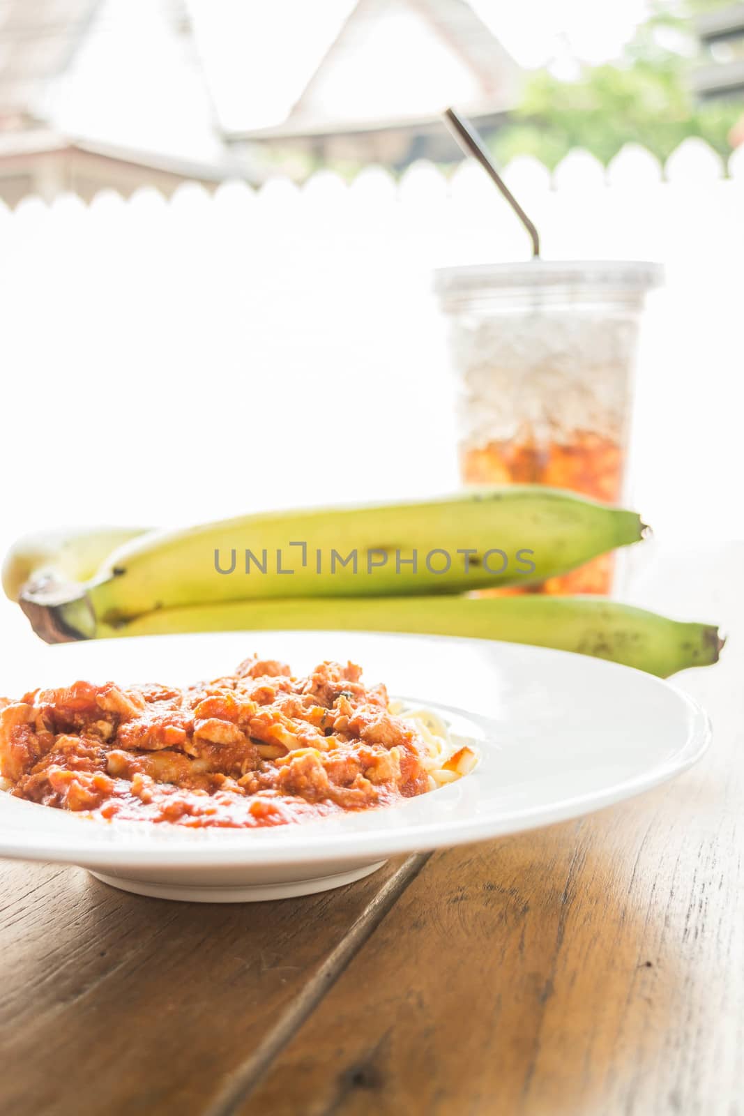 Spaghetti tomato pork sauce with fruit and drink, stock photo