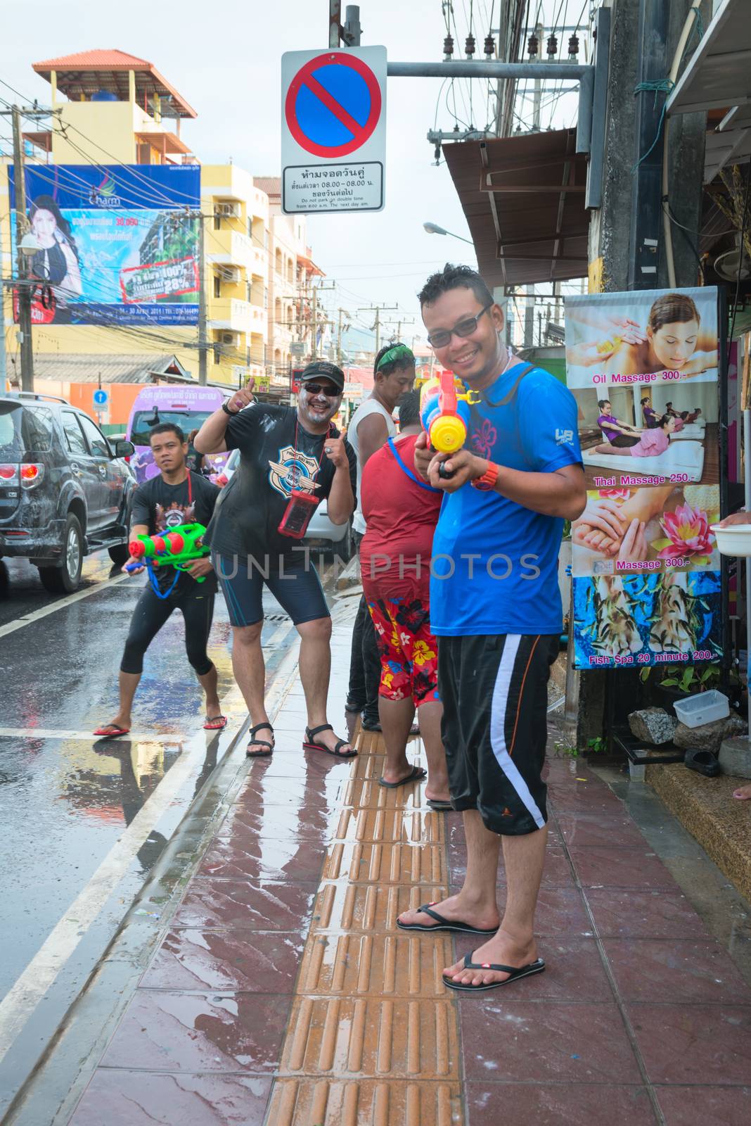 Phuket, Thailand - April 13, 2014: Tourist and residents celebrate Songkran Festival, the Thai New Year by splashing water to each others on Patong streets. 