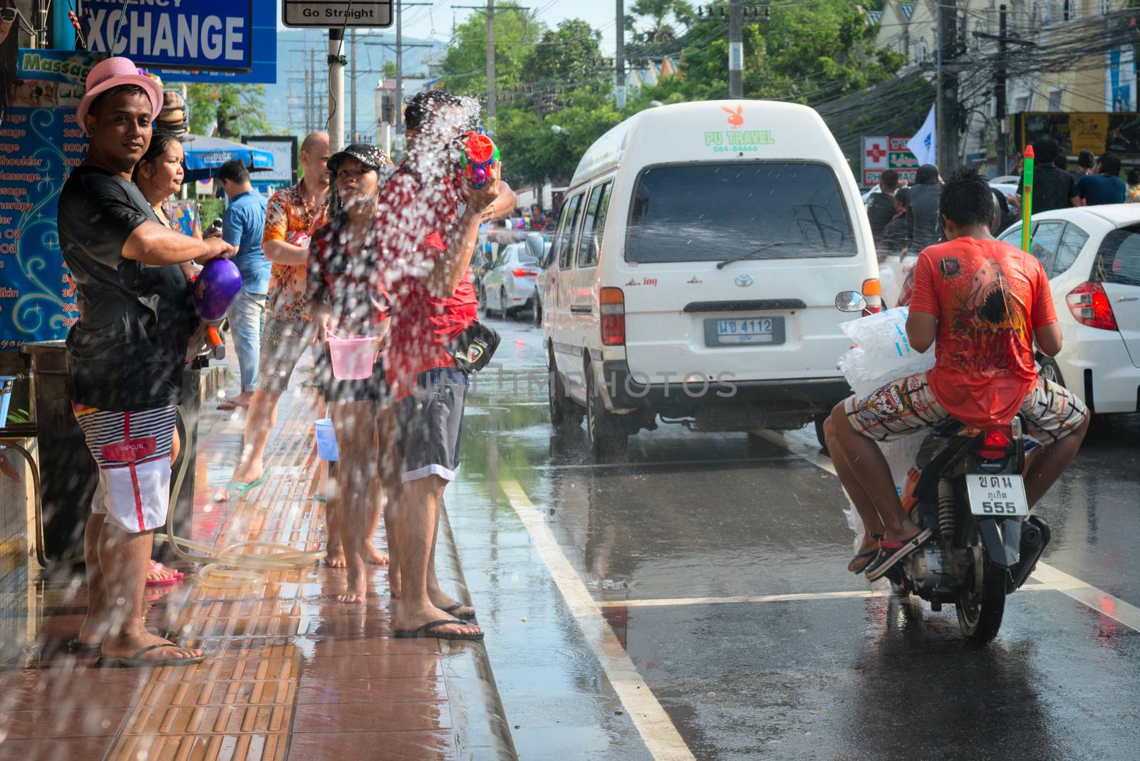 Phuket, Thailand - April 13, 2014: Tourist and residents celebrate Songkran Festival, the Thai New Year by splashing water to each others on Patong streets. 