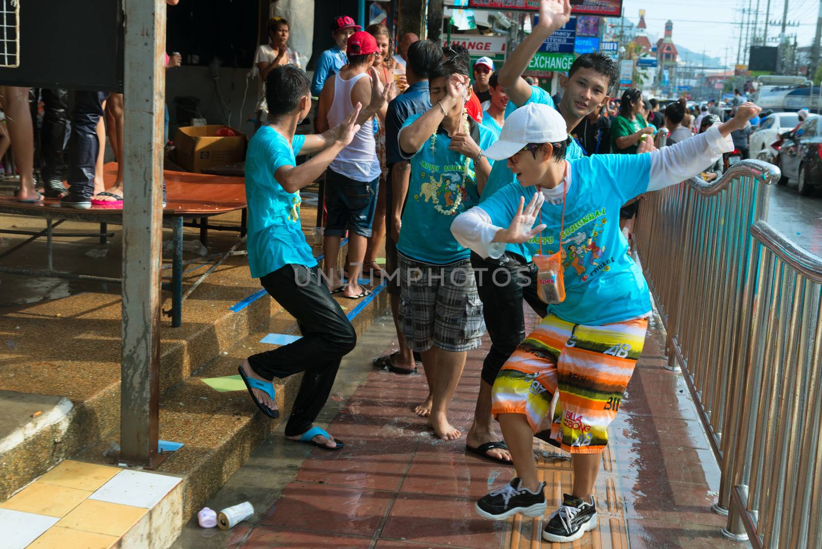 Phuket, Thailand - April 13, 2014: Tourist and residents celebrate Songkran Festival, the Thai New Year by splashing water to each others and dancing on Patong streets. 