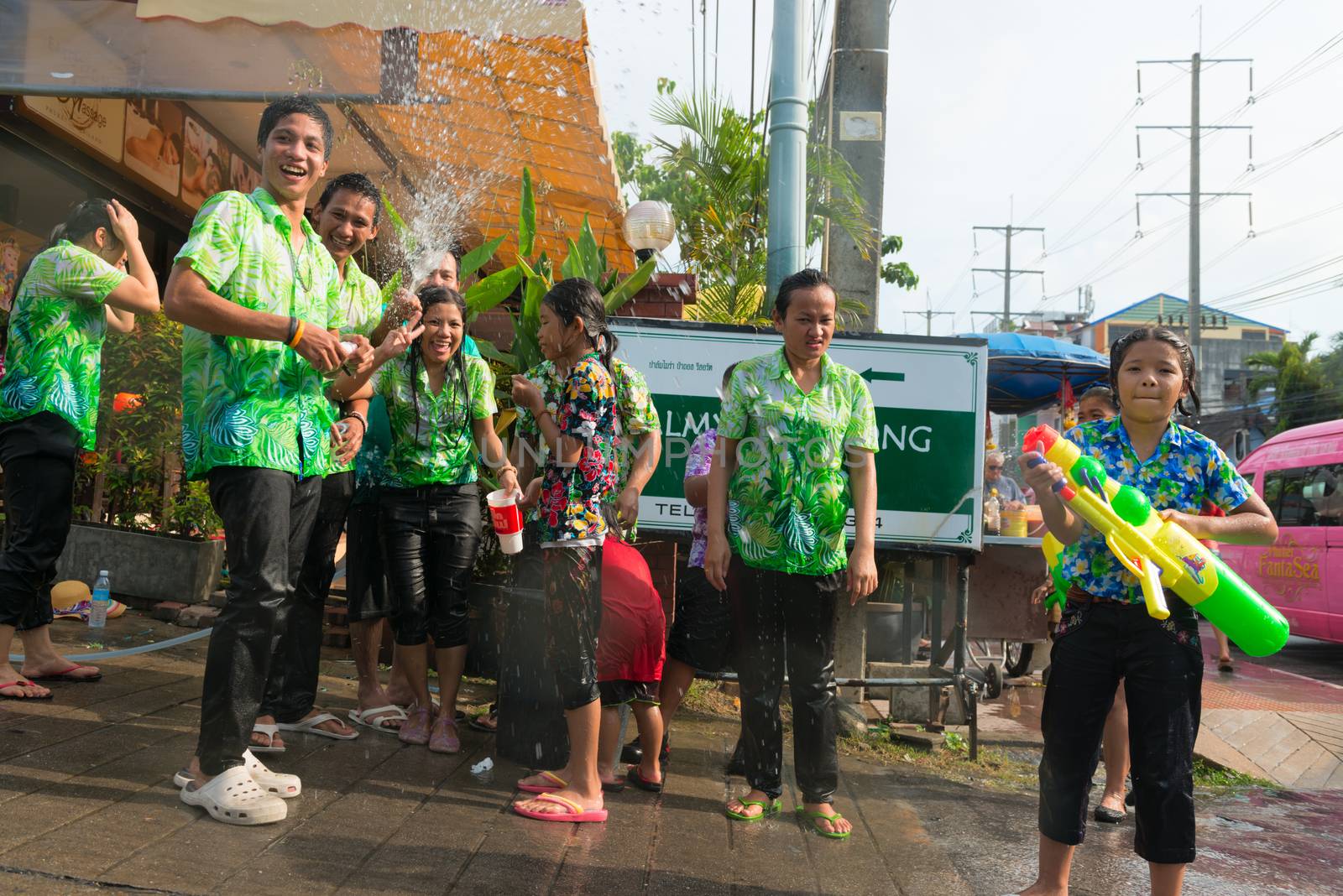 Phuket, Thailand - April 13, 2014: Tourist and residents celebrate Songkran Festival, the Thai New Year by splashing water to each others on Patong streets. 