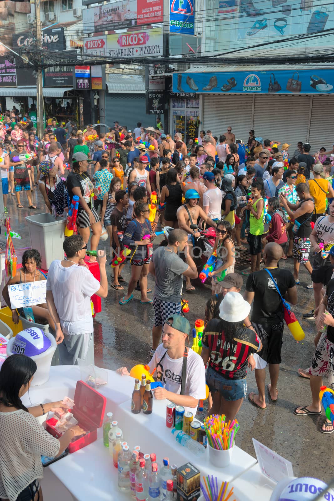 Phuket, Thailand - April 13, 2014: Tourists and residents celebrate Songkran Festival, the Thai New Year by splashing water to each others on Patong Bangla road. 