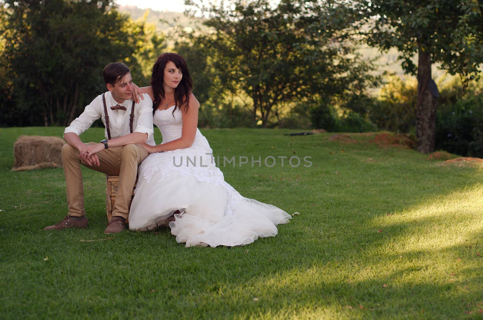 Bride and groom in garden wedding by alistaircotton