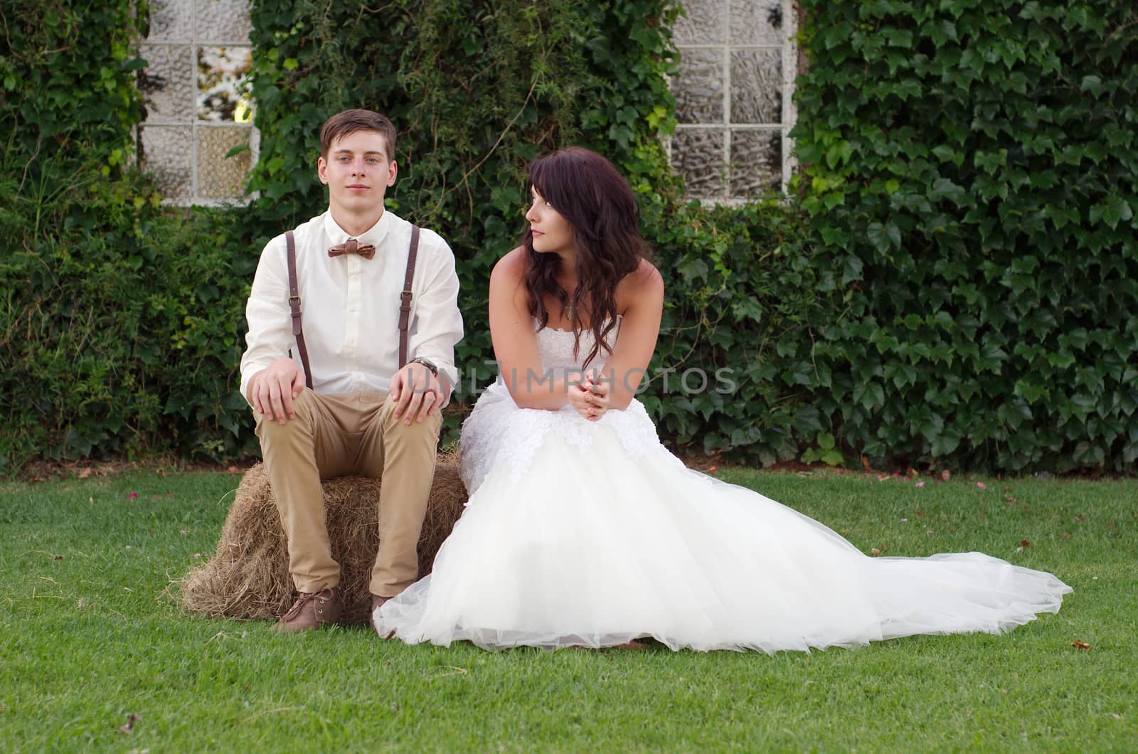 Hillbilly hipster vintage style bride and groom outside church after wedding ceremony