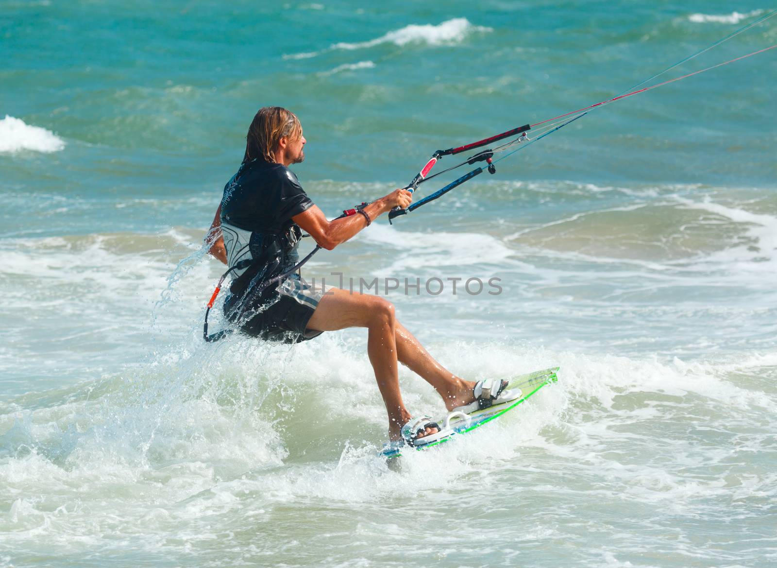 MUI NE, VIETNAM - JANUARY 28, 2014: Unidentified kitesurfer at Mui Ne resort beach on January 28, 2014 in Mui Ne resort, Vietnam