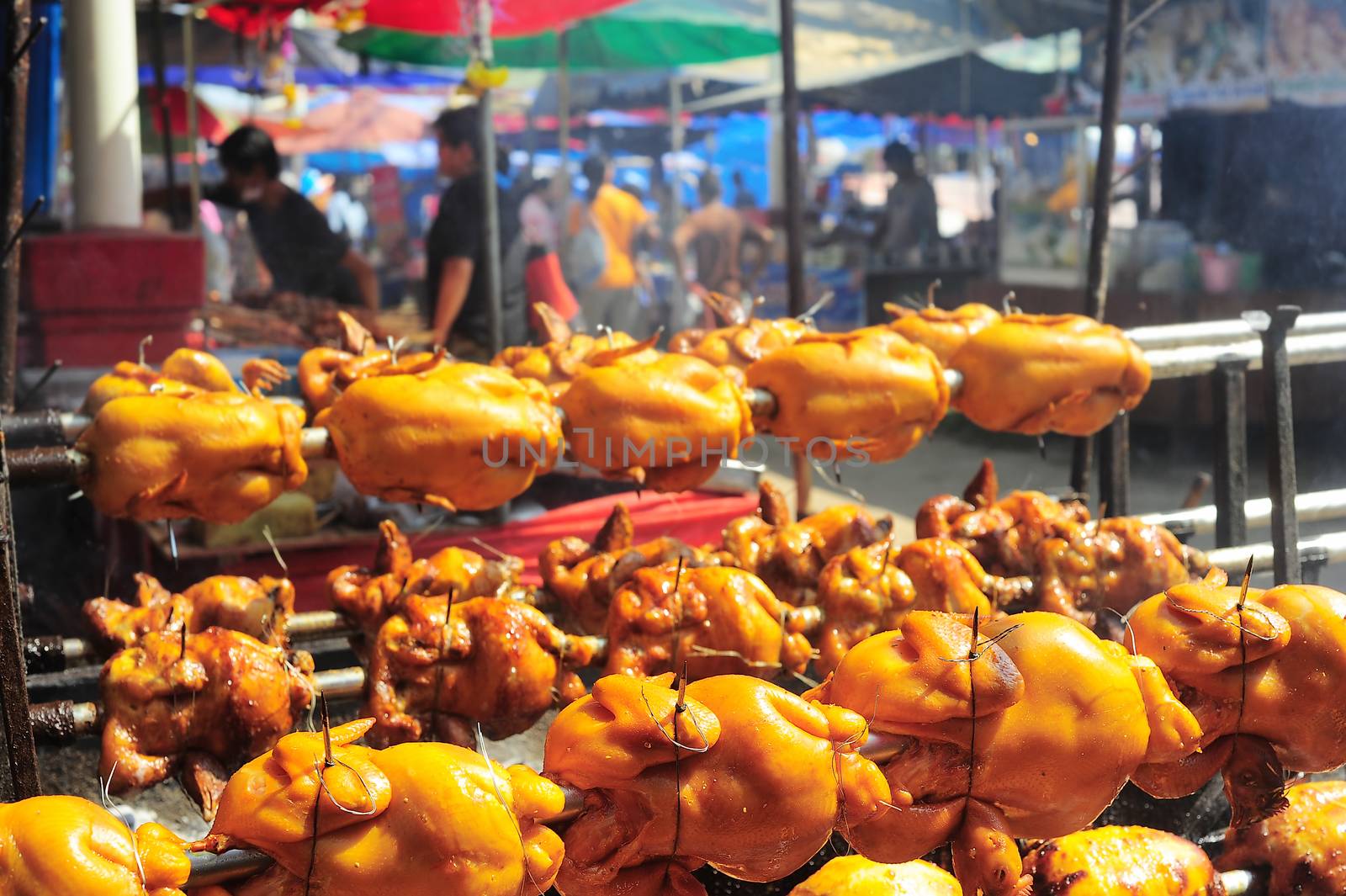 Row of grilled chicken on the rural street market in  Thailand 