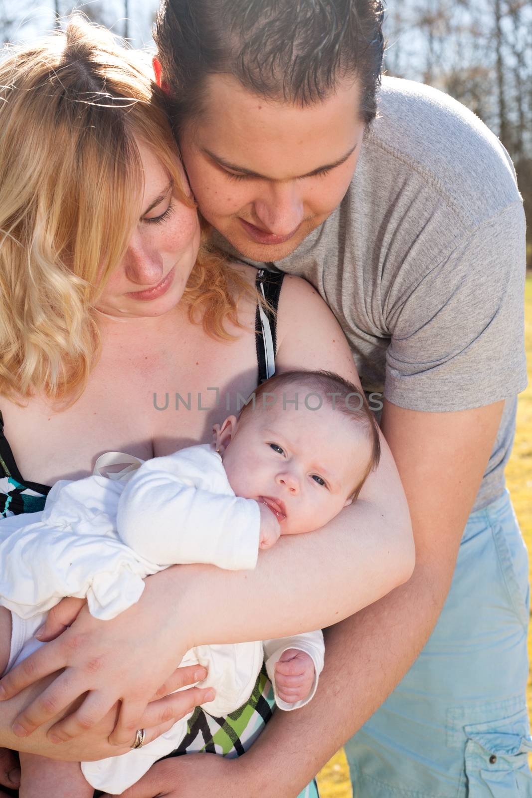 Young family is having  nice time with their baby on a sunny day