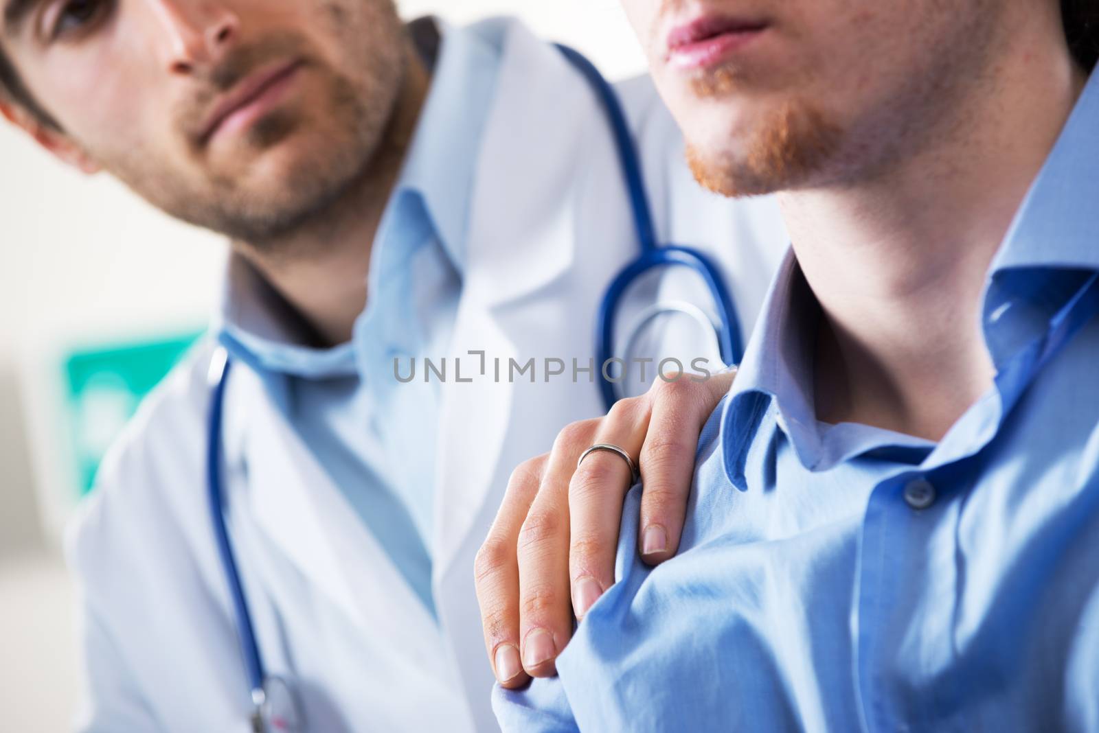 Doctor comforting a young patient after telling him bad news.