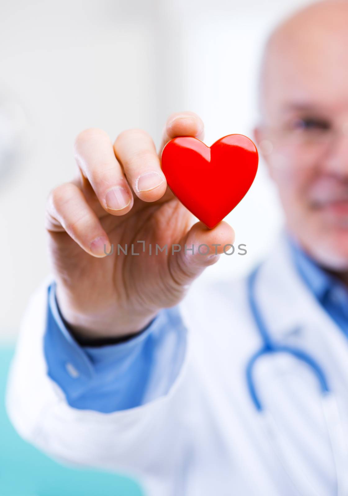 Doctor holding an heart, cardiologist and cardiovascular diseases concept.