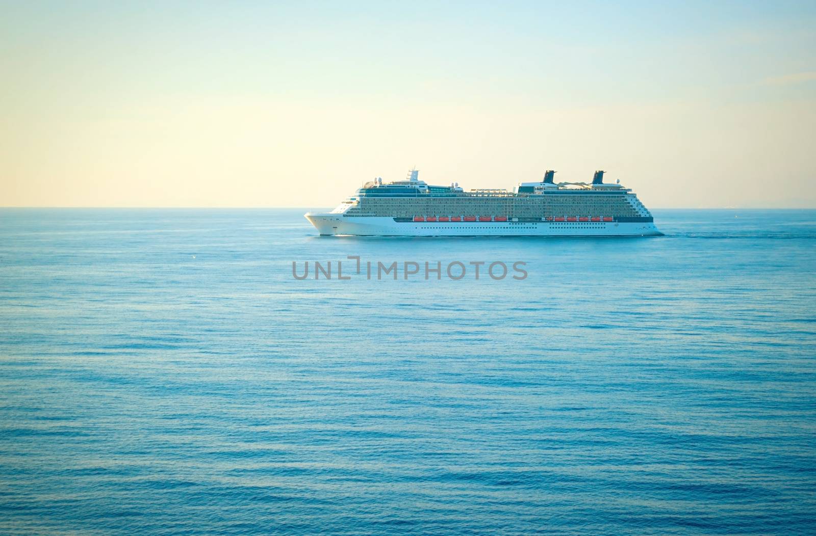 Luxury cruise liner at sunset in Mediterranean sea