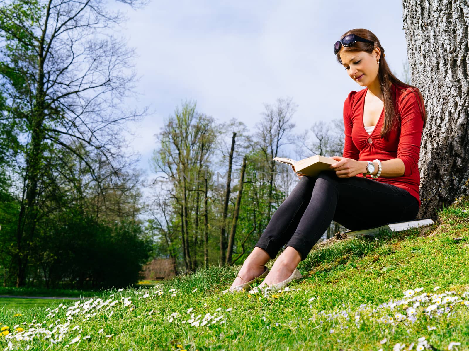 Woman reading outside in spring by sumners