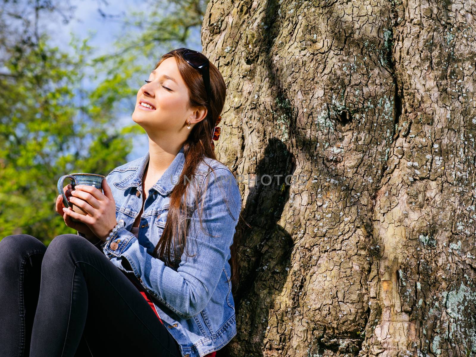 Young woman drinking and enjoying the sun by sumners