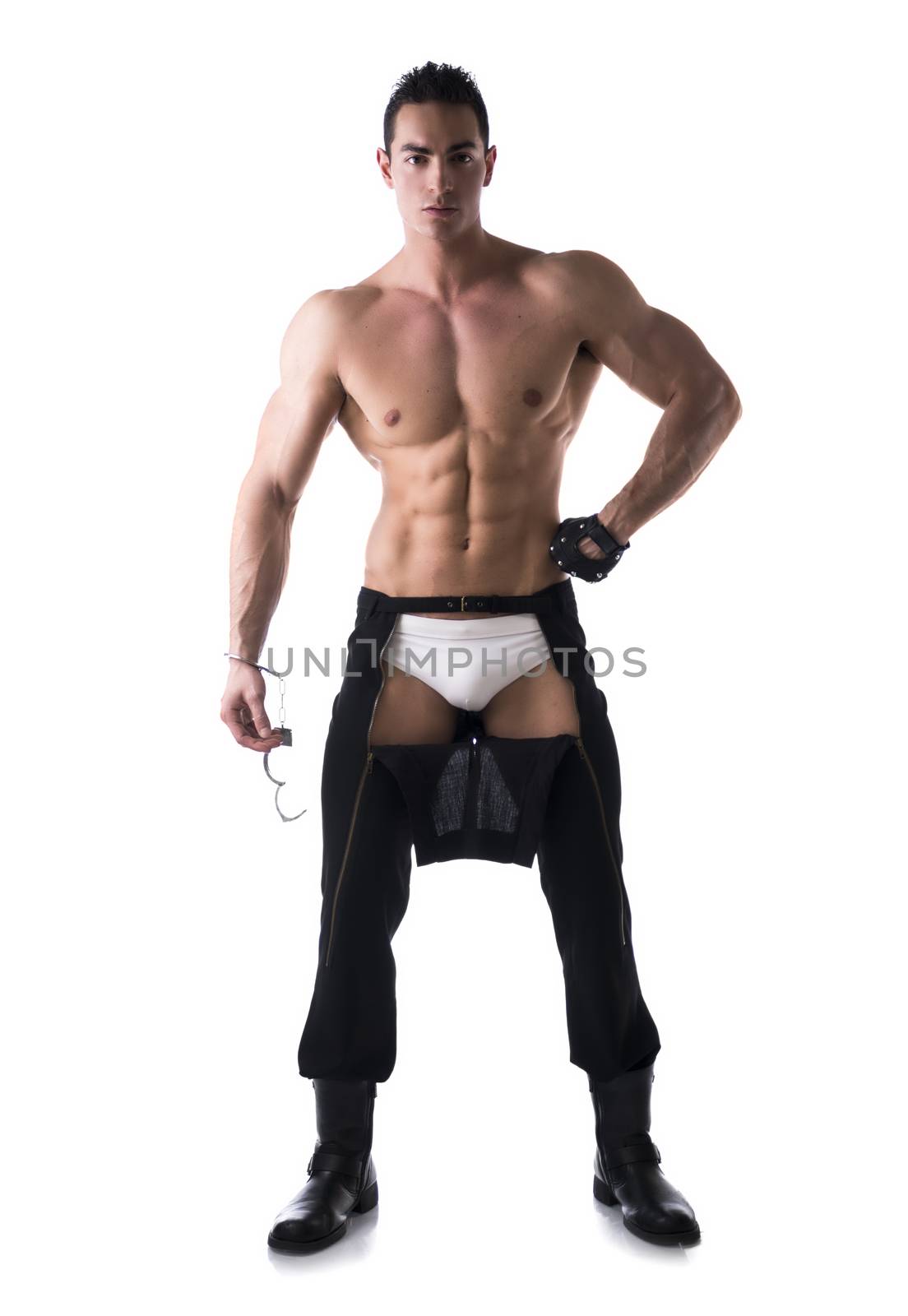 Muscular shirtless young man with handcuffs and studded glove. Full body length shot