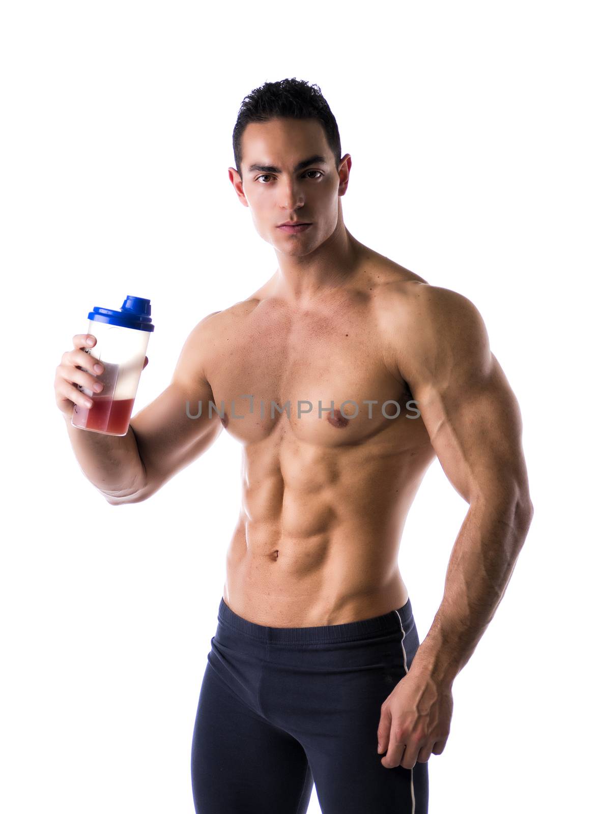 Muscular shirtless male bodybuilder holding protein shake bottle, ready for drinking. Isolated on white, looking at camera