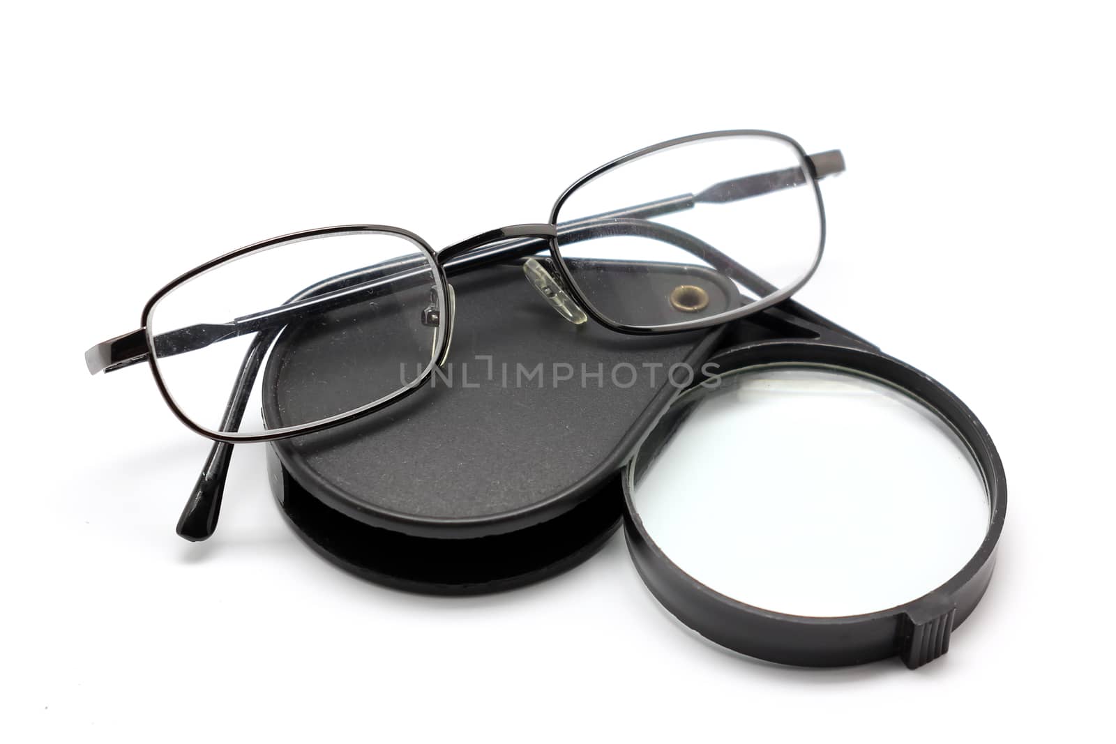 eye glasses and magnifying glass isolated on white by leisuretime70