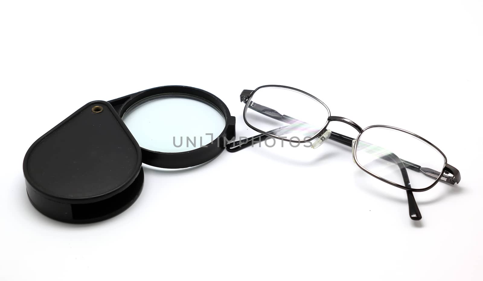 eye glasses and magnifying glass isolated on white background